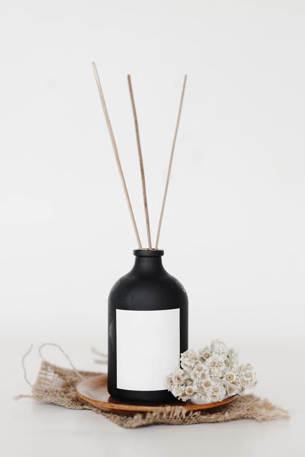 Dark perfume bottle on a stone plate